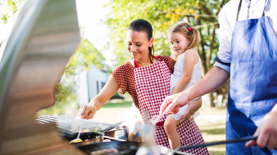 Family Cooking at Barbecue Garden Party